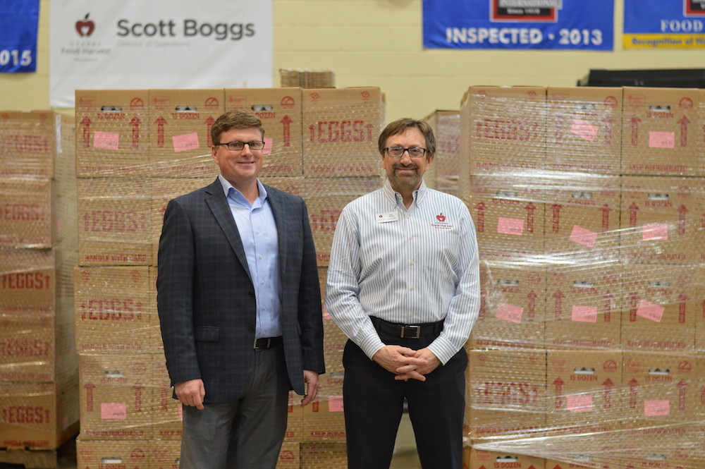 Opal Foods President Brock Peterson, left, visits Ozarks Food Harvest, represented by CEO Bart Brown, during the delivery of 280,800 eggs.
